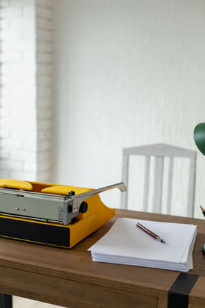 Vintage old typewriter at wooden desk table. Writer or screenwriter creative conceptの写真素材