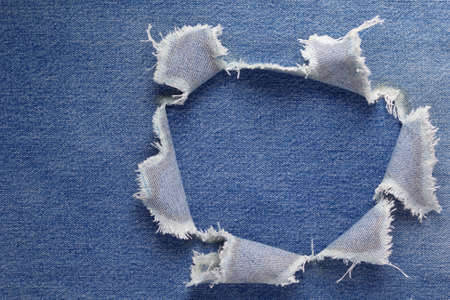 Blue jeans denim background texture. Jeans torn fabric materialの写真素材