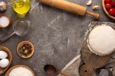 Pizza homemade cooking or baking on table. Dough pizza  at tabletop background. Recipe concept in...