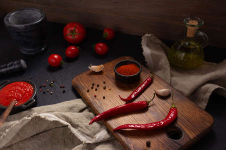 Chile pepper and tomato sauce ingredient for homemade cooking on table. Recipe concept in kitchen