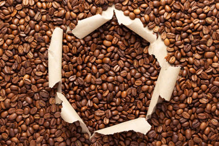 Coffee beans in torn cardboard paper. Coffee bean backround with copy spaceの写真素材