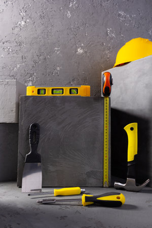 Concrete cube and construction level at brick on abstract background texture. Art or construction conceptの写真素材