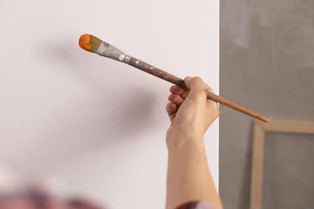 Artist working on painting. Painter hand and brush in creative studio as art conceptの写真素材