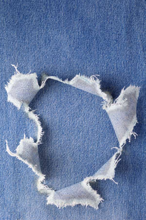 Blue jeans denim background texture. Jeans torn fabric material surfaceの写真素材