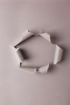 Grey torn paper as background texture. Gray abstract paperの写真素材