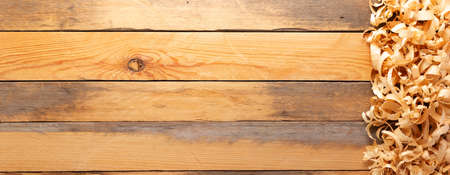 Wood shavings on table background. Wooden shaving at old plank board textureの写真素材