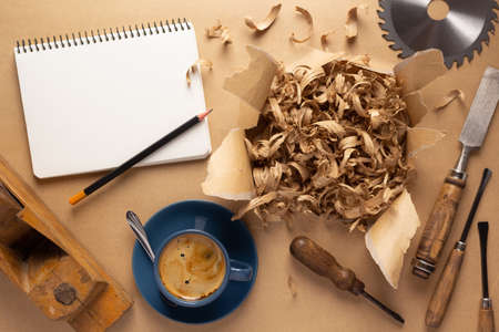 Woodworking carpenter chisel tool and wood shavings at paper background. Chisel as joiner toolの写真素材