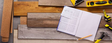 Wood laminate and tools at floor background texture. Wooden laminate top view