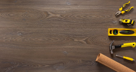Wood laminate and tools at floor background texture. Wooden laminate top view