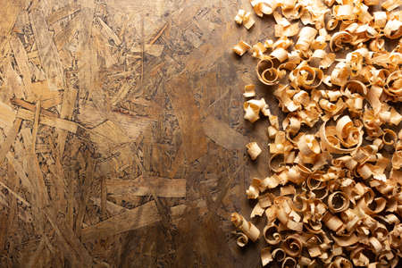 Wood shavings on table background. Wooden shaving at old plank board textureの写真素材