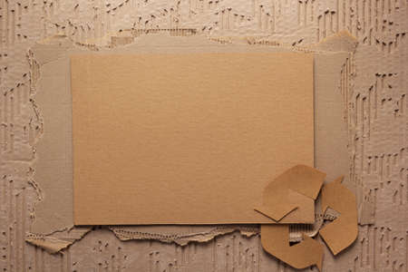 Recycle symbol at stack of recycled paper as background texture. Recycling idea concept and brown paperの写真素材