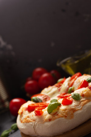 Italian pizza with ingredients at table. Pizza cooking on tabletop backgroundの写真素材