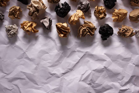 Crumpled paper balls at white folded background texture. Inspiration creative idea conceptの写真素材