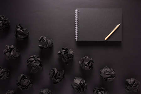 Crumpled paper balls at black background texture. Inspiration creative idea conceptの写真素材