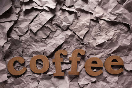 Coffee letters on torn paper background textureの写真素材