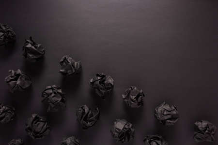 Crumpled paper balls at black background texture. Inspiration creative idea conceptの写真素材