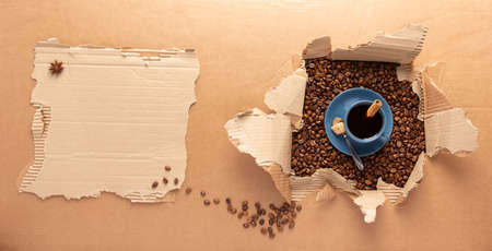 Cup of coffee and beans in brown cardboard paperbackground. Relax coffee conceptの写真素材
