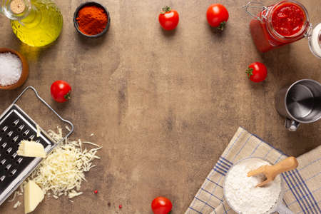 Pizza ingredients at table. Bread recipe cooking on tabletop backgroundの写真素材