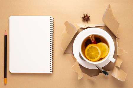 Cup of tea with lemon and honey in torn paper. Mug full of teaの写真素材