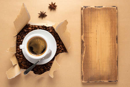 Cup of coffee and beans in paper background. Relax coffee conceptの写真素材
