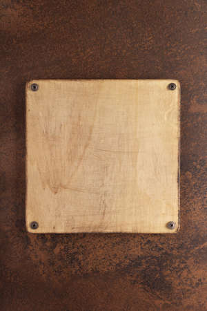 Wooden nameplate or sign board screwed on wall background. Front view of name plateの写真素材