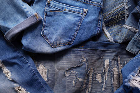 Heap of torn jeans denim as background texture. Blue jeans fabric material surfaceの写真素材