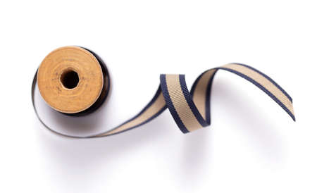 Spool with ribbon isolated at white background, top view. Sewing ribbon roll