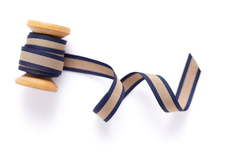 Spool with ribbon isolated at white background, top view. Sewing ribbon rollの写真素材