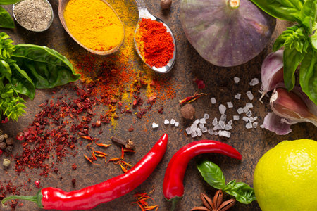 Variety of spices and herbs on table background. Cooking concept and ingredients at table top viewの写真素材