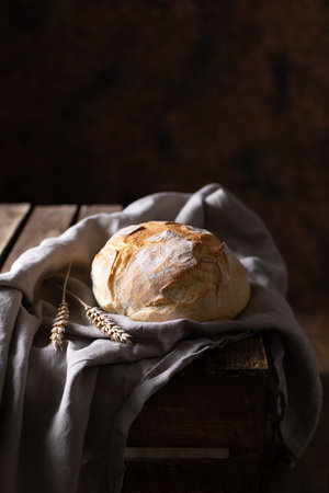 Bread and cloth napkin on table. Homemade bread at wooden tabletop as baking conceptの写真素材