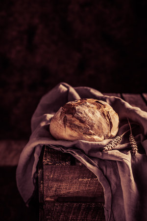 Homemade bread and cloth napkin on table. Bakery concept at wood tabletopの写真素材