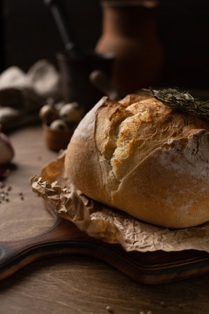 Homemade bread with parchment paper on wood table. Bread at wooden tabletop as baking conceptの写真素材