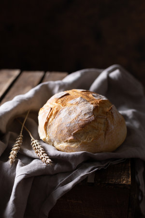 Bread and cloth napkin on table. Homemade bread at wooden tabletop as baking concept