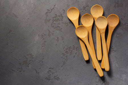 emty wooden spoon on concrete stone table backgroundの写真素材
