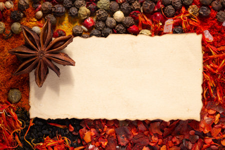 Variety of spices and ingredients with aged paper as cooking recipe concept closeupの写真素材