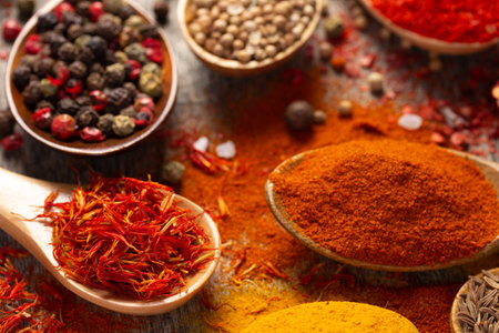 Variety of spices in spoon on table background. Cooking concept and ingredients at kitchen table closeupの写真素材