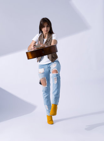 Young woman hand over acoustic guitar. Musician in life style holding classic guitarの写真素材