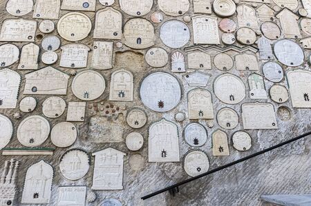 The entire wall along the stairs is occupied by reliefs of monasteries and churches from different parts of the world . Each image has a small reliquary , which holds the land , brought pilgrims from the holy places.の写真素材
