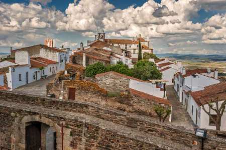 Monsaraz - a small border Portuguese fortress on top of a hill overlooking the vast expanses of the Alentejo vineyards, olive groves, and neighboring Spain Guadianu River, a natural border of Spain and Portugalのeditorial素材
