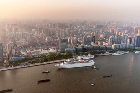 China, Shanghai. View from the Oriental Pearl Tower in the old part of the city and the Bund, Huangpu River. Ships on the river.の写真素材