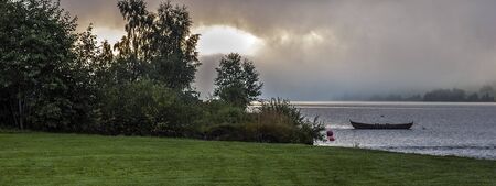 Norway, Neroyfiord. Early misty morning, fishing boats on the water.