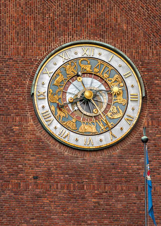 Oslo - the capital of Norway. The clock on one of the towers of the City Hall. Clear sunny summer day.の写真素材