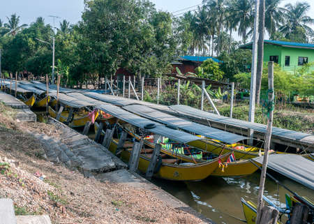 Thailand, Bangkok. Parking tourist boats Long Tail on one of the channels of the Chao Phraya River.の写真素材