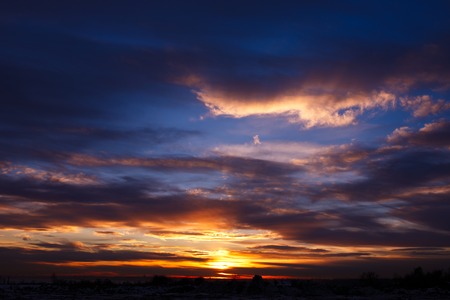 Magnificent sunset with red clouds a windy dayの写真素材