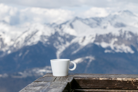 Cup of Tea on Snow Mountains Backgroundの写真素材