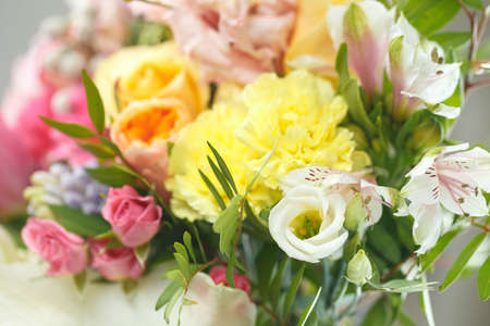 delicate bouquet of bright flowers isolated on whiteの写真素材