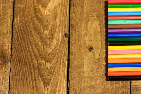 Composition with colorful pencils on old wooden tableの写真素材