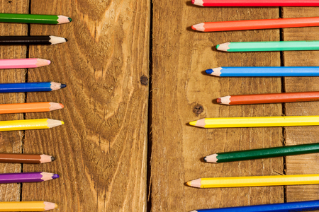 Composition with colorful pencils on old wooden tableの写真素材