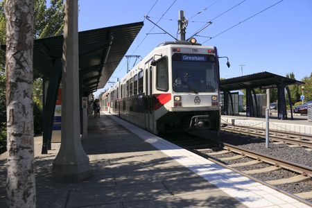 Beaverton, Oregon, August 3, 2010 - An electric light rail public Max train is at the Elmonica station picking up people.のeditorial素材