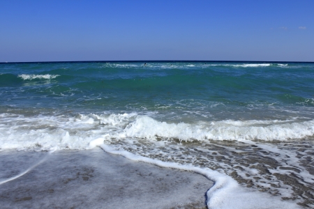 People playing in the warm Atlantic ocean water off the coast of John U  Lloyd Beach State Park in Dania Beachの写真素材